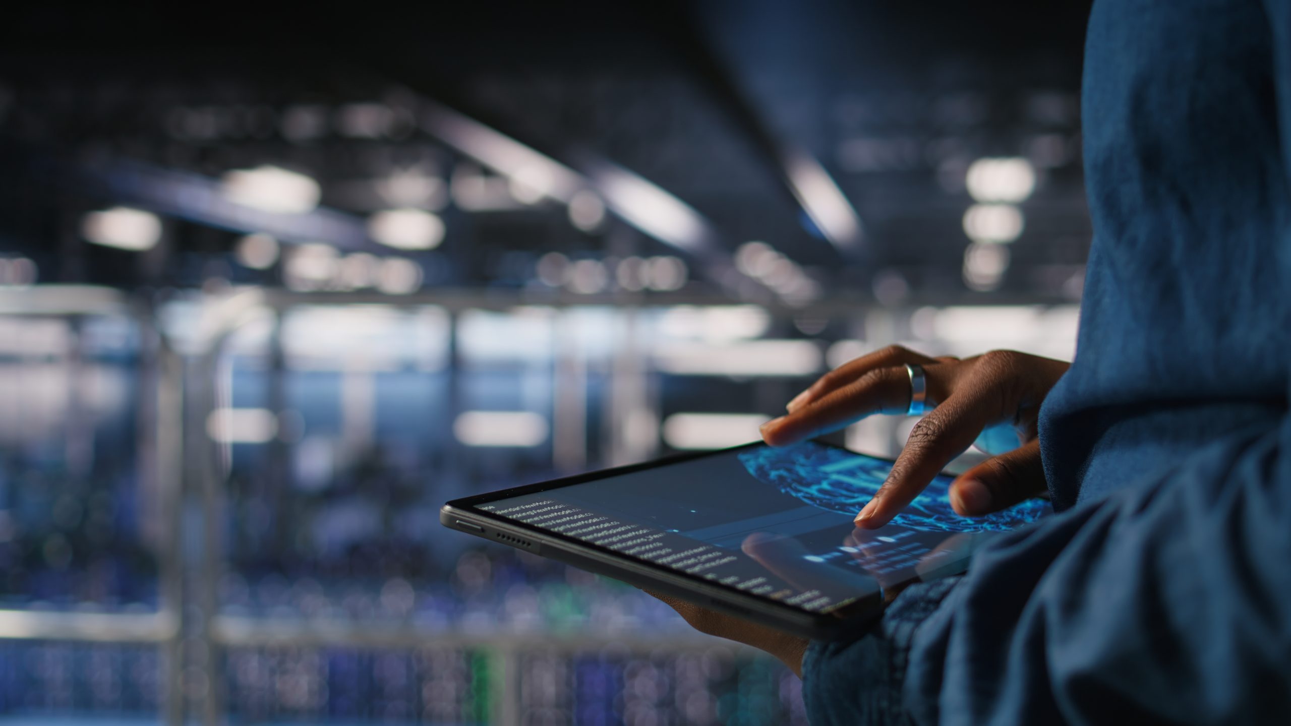 Close up of data center engineer using tablet, doing maintenance on AI rigs