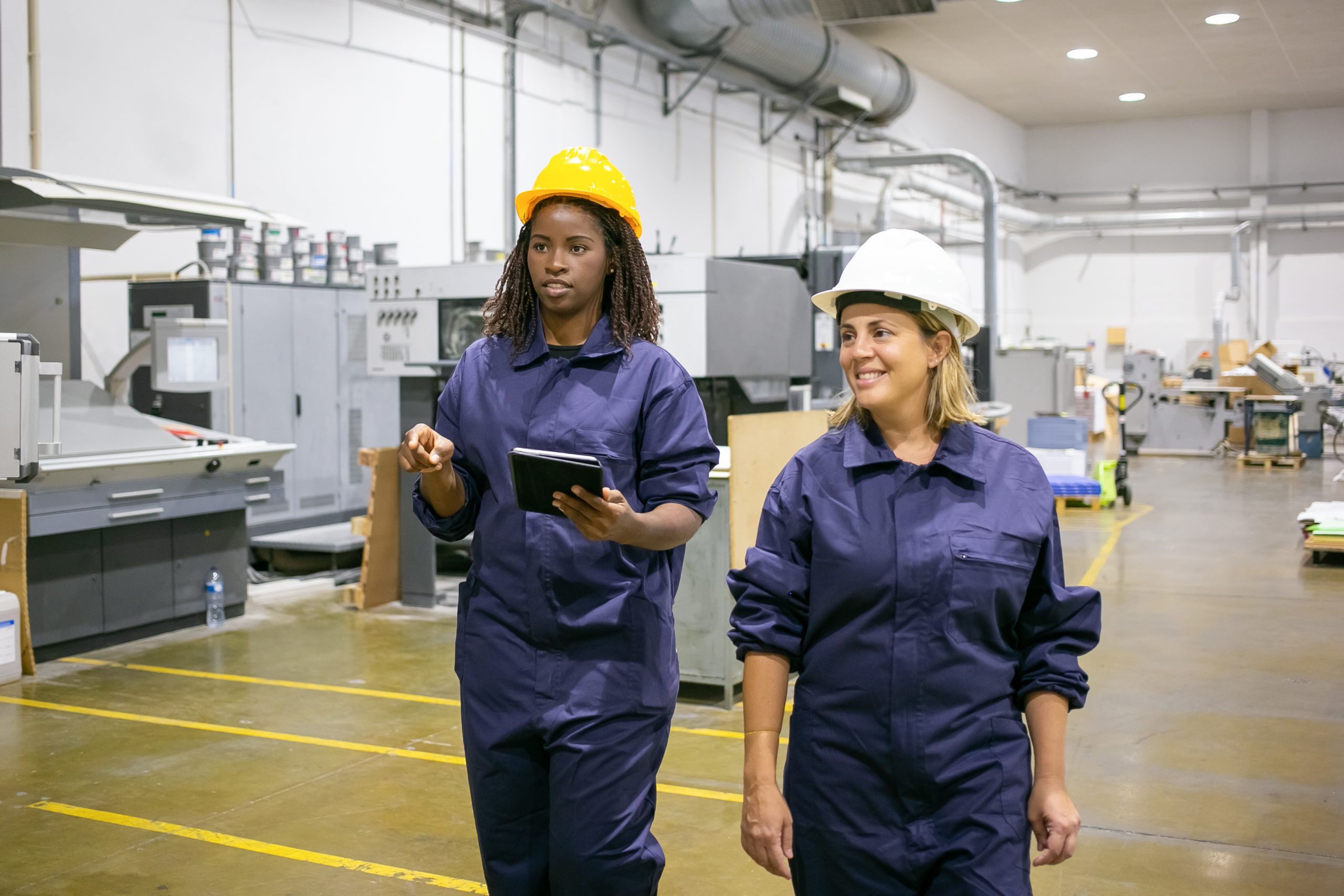 African American worker pointing, talking with colleague